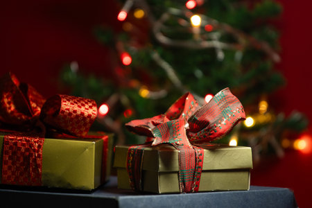 gift boxes with a Christmas tree in backgroundの写真素材