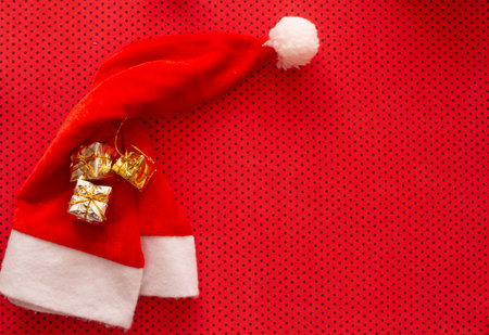 santa claus hat with mini gift boxes on topの写真素材