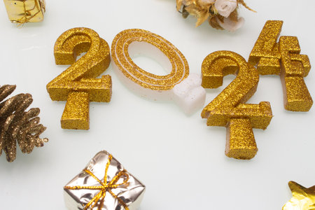 2024 written with golden letters on white background with ornamentsの写真素材