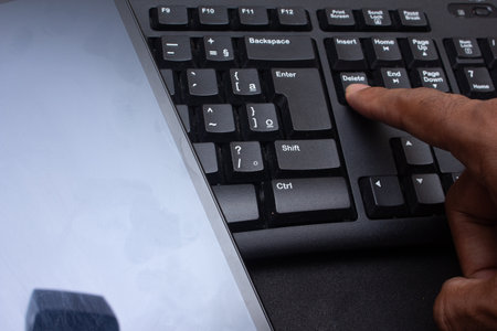 hand typing on keyboard close to tableの写真素材