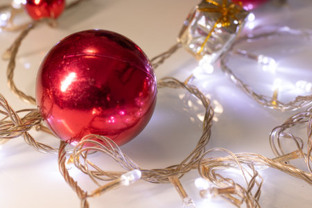 red ball surrounded by Christmas lights and giftsの写真素材