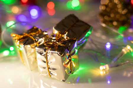 colored christmas lights with several gift boxesの写真素材