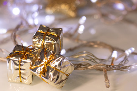 golden christmas boxes and christmas lightsの写真素材