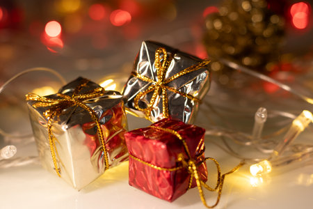 golden christmas lights with several gift boxes