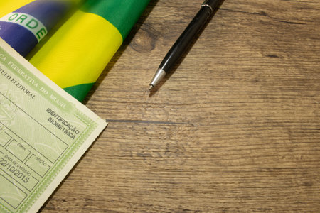 LAURO DE FREITAS, BRAZIL - April 26, 2024Brazilian voter registration card next to the Brazilian flagの写真素材