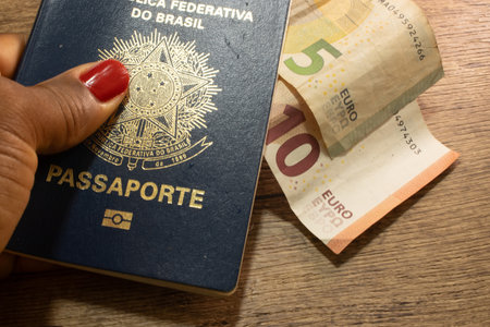 LAURO DE FREITAS, BRAZIL - April 26, 2024 : Brazilian passport with euros on the sideの写真素材