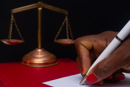 hand writing with scales of justice in an institutional environment