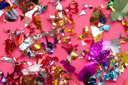 Colorful paper confetti on pink background. Flat lay, top view.の写真素材