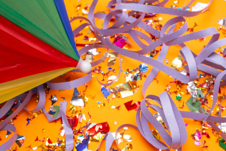 Party decoration with confetti and ribbons on a bright background.の写真素材