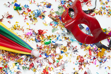 Carnival mask with confetti and streamers on white backgroundの写真素材
