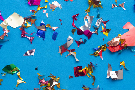 Colorful paper confetti on blue background. Festive concept.の写真素材
