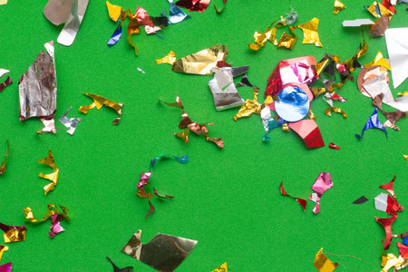 Colorful confetti on green background. Celebration concept. Top view.の写真素材