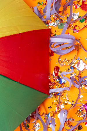 Colorful confetti and ribbons on orange background, top viewの写真素材