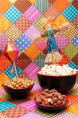 Colorful patterned background with a doll and a bowl of popcornの写真素材