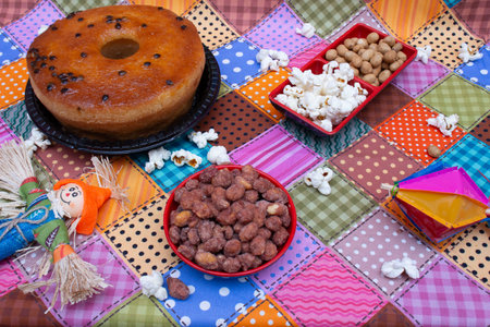 Donut with nuts and popcorn on the tablecloth in the kitchenの写真素材