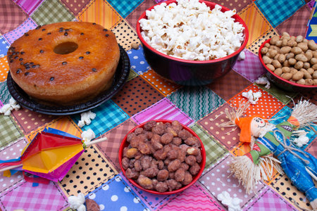 Chocolate donut with nuts and popcorn on colorful tablecloth.の写真素材