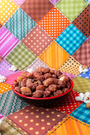 A bowl of dried fruits on a colorful patchwork background.の写真素材