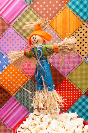 A closeup shot of a scarecrow with popcorn on a colorful backgroundの写真素材