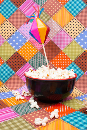 Popcorn in a bowl on colorful patchwork background. Shallow doff.の写真素材