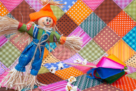 Handmade scarecrow against a colorful patchwork background. Selective focus.の写真素材