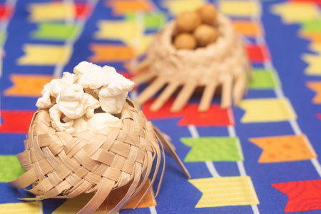Close up of nuts in bamboo basket on colorful tablecloth background.の写真素材