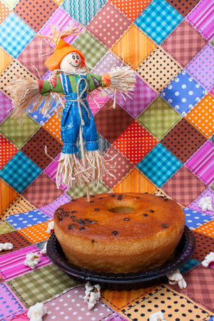 Homemade cake with raisins in the form of a scarecrow on the background of a colorful fabricの写真素材