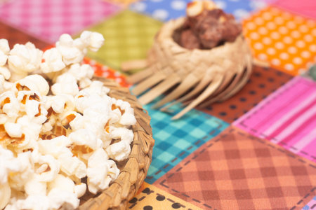 Popcorn in a basket on colorful tablecloth. Selective focus.の写真素材