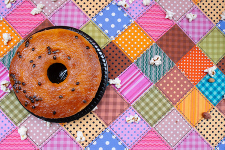Donut with chocolate chips on colorful patchwork background. Top view.の写真素材