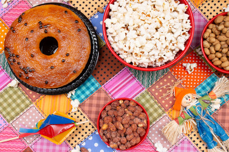Cupcake, popcorn and raisins on colorful tableclothの写真素材