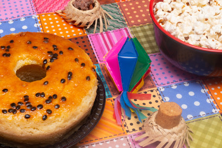 Donut with chocolate chips and popcorn on colorful tablecloth background.の写真素材