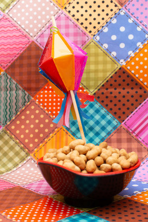 Cashew nuts in a bowl with colorful paper kite on colorful backgroundの写真素材