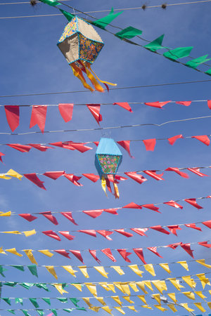 Colorful kites and flags on a blue sky background in Thailandの写真素材