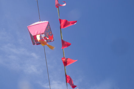 Colorful pennants on blue sky background, closeup of photoの写真素材