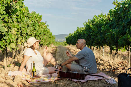 Couple talking and eating in a beautiful placeの写真素材