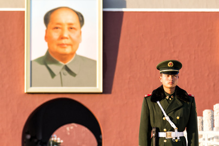 Beijing, China - November 4, 2013. An unidentified soldier stands guard in the front of the Chairman Mao portrait on the wall of Tiananmen Gate, south entrance of the Forbidden Cityのeditorial素材