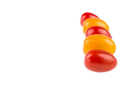Yellow and red cherry tomatoes on white backgroundの写真素材