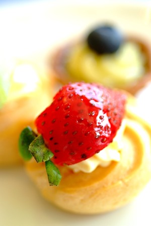 Delicious strawberry puff on a white plateの写真素材