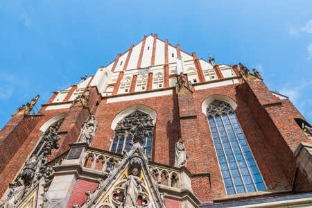 Architectural detail of the beautiful gothic church in Nysa located on the market square. Basilica of st. James the Apostle and St. Agnieszka in Nysa. Gothic styleの写真素材