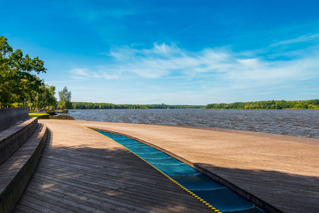view of the paprocaÅskie lake in Tychy. Wooden platforms in the foreground. Water plants and sailboats. A beautiful sunny day. Canoe harborの写真素材