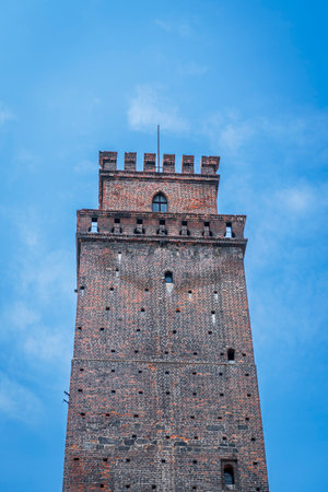 Nysa, Poland - May 1, 2022:Tower. Medieval gate tower. A gothic building made of red and brown bricks against blue sky.のeditorial素材