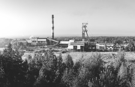 Beautiful, black and white, view on coal mining 'Boze Dary' in Katowice, Silesia, Poland seen from mining heap at sunrise. Nature versus industry. A mine surrounded by forest.のeditorial素材