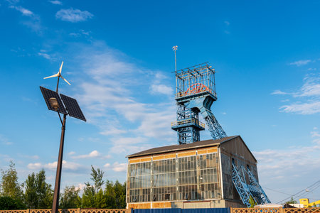 Summary of new and old technologies of energy production. Street lamp with a photovoltaic panel, a windmill and an old mine shaft. Siemianowice ÅlÄskie, Polandのeditorial素材