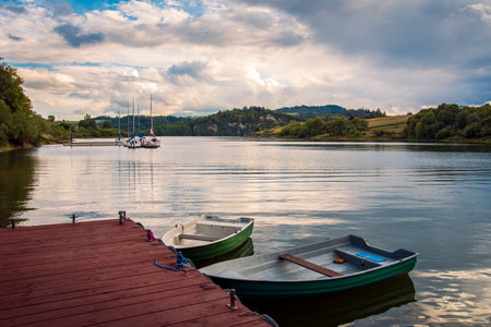 Boats moored to the pier. A beautiful bay on the Czorsztyn Lake. A small marina in the background. Czorsztyn, Polandの写真素材