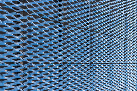 Perforated metal sheet stamping plates - angle view. Light reflection and shadow.