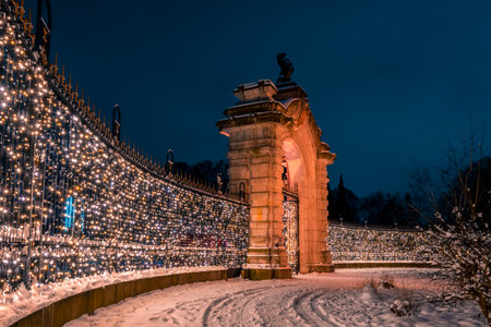 Lightened main entrance gate of the zoo located in Silesian Park, Chorzow, Poland. Beautiful, winter scenery. Colorful illumination. Christmas time.の写真素材