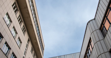View of modernist buildings against the sky from a human perspectiveの写真素材