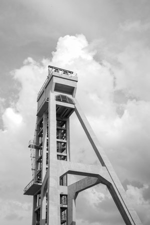 The tower of the former mine shaft against the blue sky. Currently an observation tower. A monument of technology. Black and white photo. Shaft President, Chorzow, Polandの写真素材