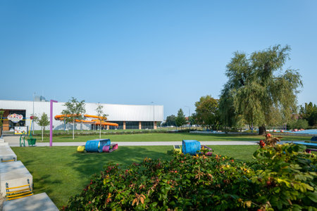 Blonie, Poland - August 20, 2023: Urban green area with playgrounds, a skate park and a sports center with a swimming pool. Sports center. Park "Bajka", BÅonie, Poland.のeditorial素材