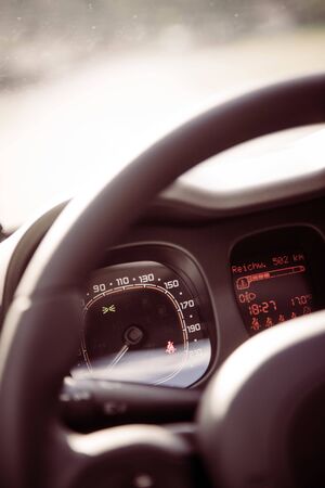 Close up of a steering wheel with remote control, blurry dashboardの写真素材