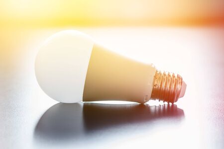 White light bulb lying on a desk, concept for ideas. Sunlight.の写真素材